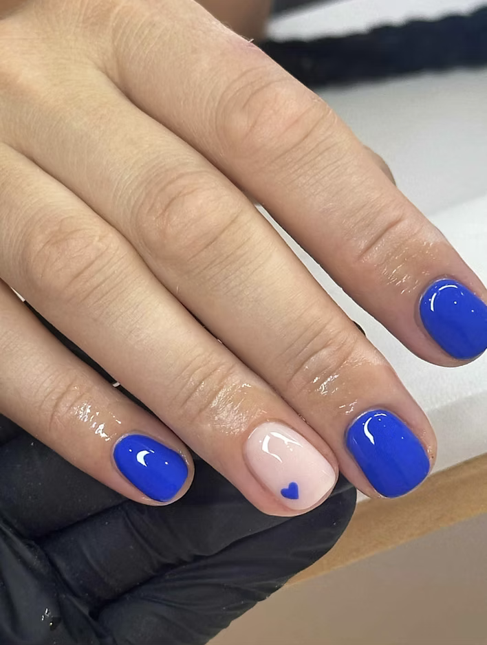 Cobalt blue short gel nails with a nude heart accent
