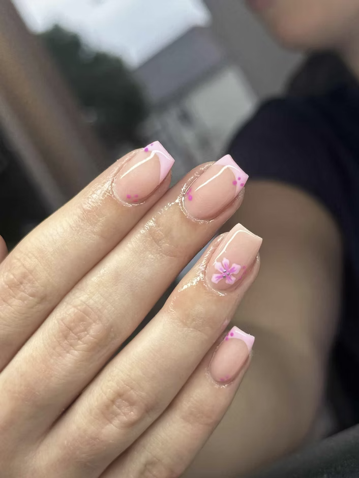 Pink French tips with hand-painted flowers
